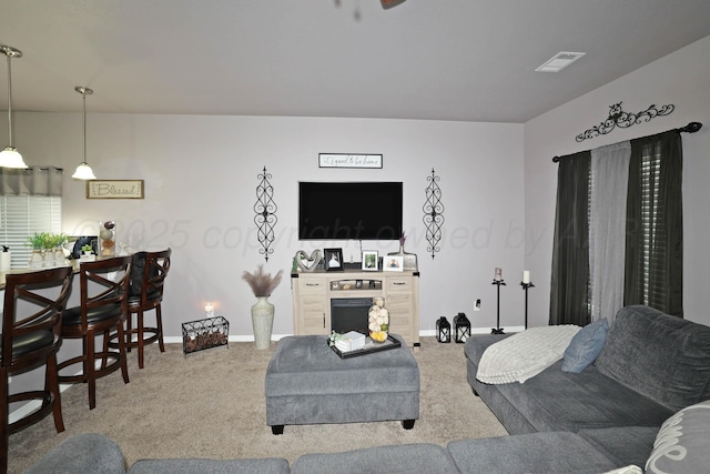 4908 Gloster St, Amarillo, TX 79118 - living area with carpet flooring, baseboards, and a fireplace