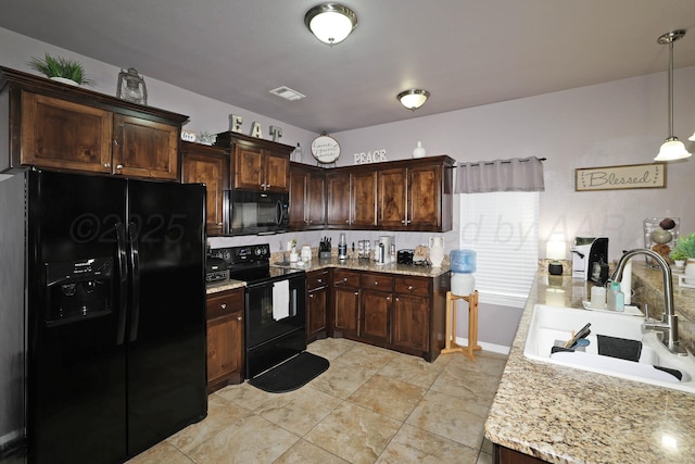 4908 Gloster St, Amarillo, TX 79118 - kitchen with black appliances, a sink, dark brown cabinetry, decorative light fixtures, and light stone countertops
