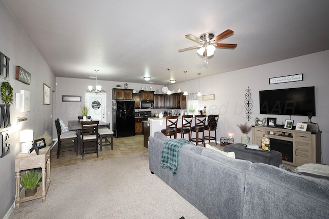 4908 Gloster St, Amarillo, TX 79118 - living area with a chandelier, a ceiling fan, a fireplace, and light carpet