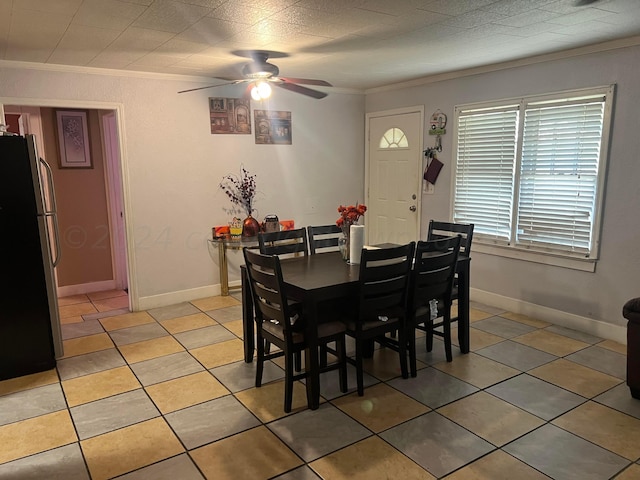 dining space with tile patterned flooring, ceiling fan, and crown molding