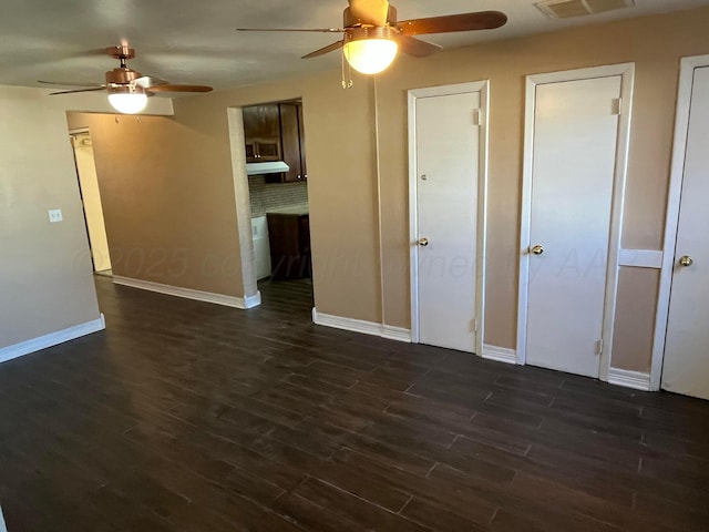 3601 NE 13th Ave, Amarillo, TX 79107 - unfurnished living room with ceiling fan and dark wood-type flooring