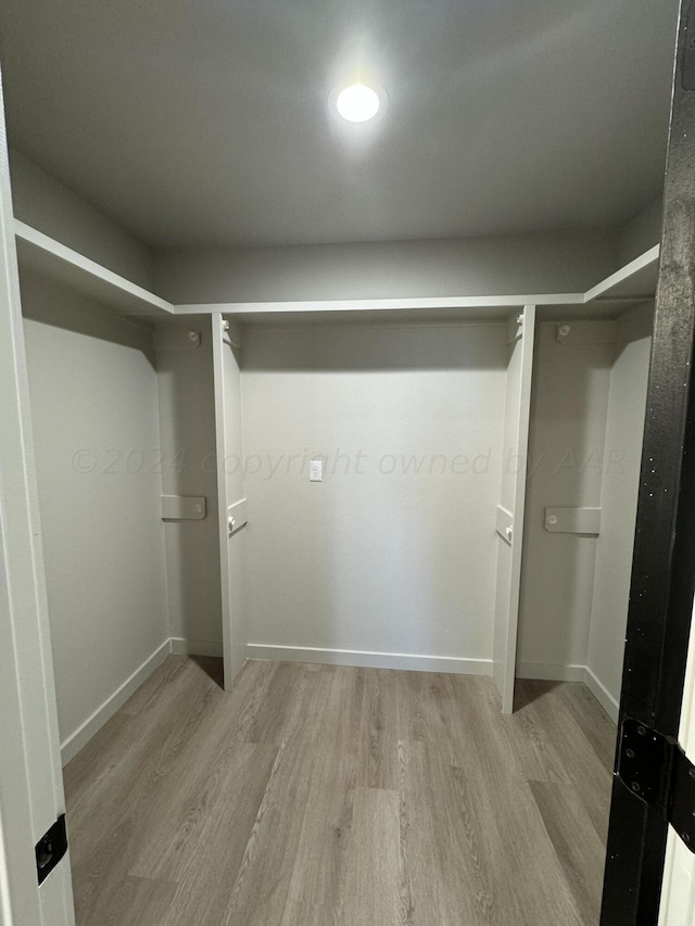 walk in closet featuring light hardwood / wood-style floors