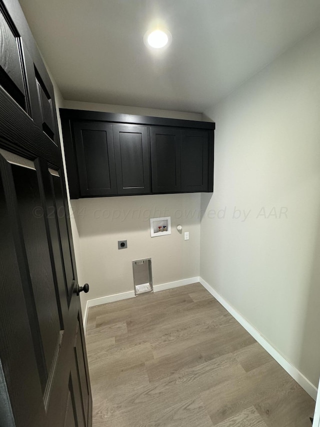clothes washing area with light hardwood / wood-style flooring, washer hookup, cabinets, and hookup for an electric dryer