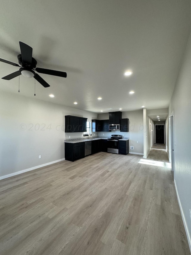 kitchen with light hardwood / wood-style floors, ceiling fan, and appliances with stainless steel finishes