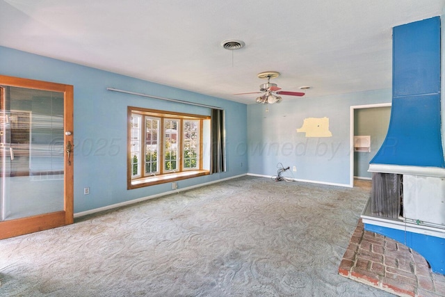 unfurnished living room with carpet flooring, baseboards, and ceiling fan