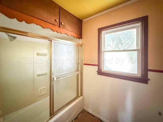 full bath featuring shower / bath combination with glass door, ornamental molding, and tile patterned floors