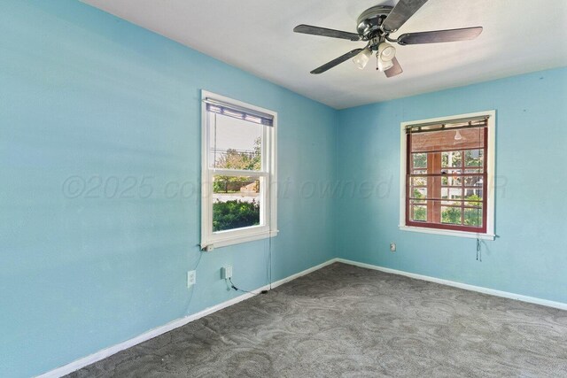 carpeted empty room featuring baseboards and a ceiling fan