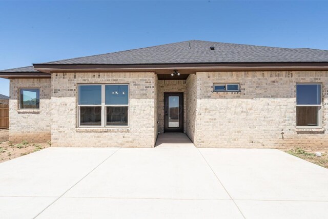 1634 Northridge St, Dumas, TX 79029 - rear view of house with a shingled roof and a patio area