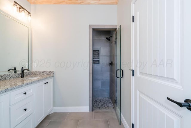 1634 Northridge St, Dumas, TX 79029 - full bathroom featuring a shower stall, tile patterned flooring, vanity, and baseboards