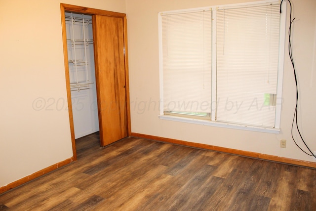 219 Kiekbusch St, Borger, TX 79007 - unfurnished bedroom featuring a closet, dark wood finished floors, and baseboards