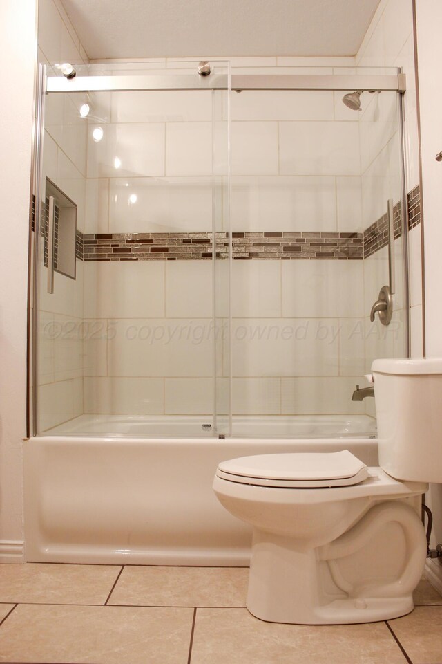 219 Kiekbusch St, Borger, TX 79007 - bathroom featuring toilet, shower / washtub combination, and tile patterned floors