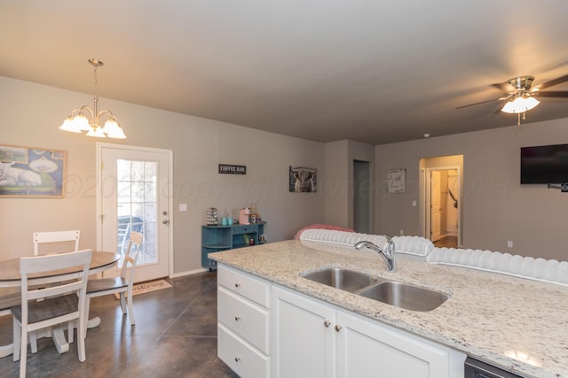 5007 Ratliff St, Amarillo, TX 79118 - kitchen featuring concrete flooring, a chandelier, white cabinetry, hanging light fixtures, and open floor plan