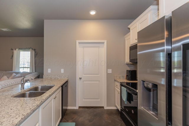 5007 Ratliff St, Amarillo, TX 79118 - kitchen with stainless steel fridge with ice dispenser, electric range, black microwave, white cabinetry, and light stone countertops