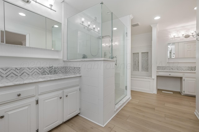 514 Melody Ln, Amarillo, TX 79118 - full bath featuring a shower stall, crown molding, backsplash, wood finished floors, and vanity
