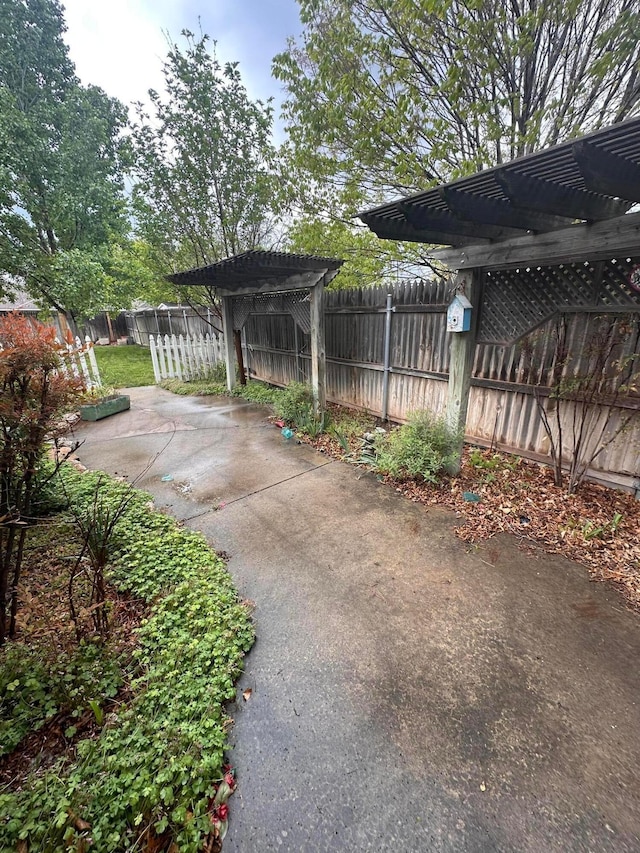 view of patio featuring a pergola and fence