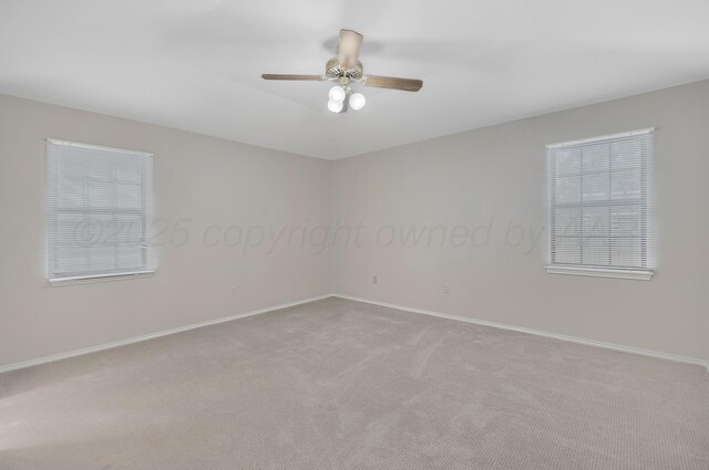 unfurnished room with carpet floors, ceiling fan, and baseboards