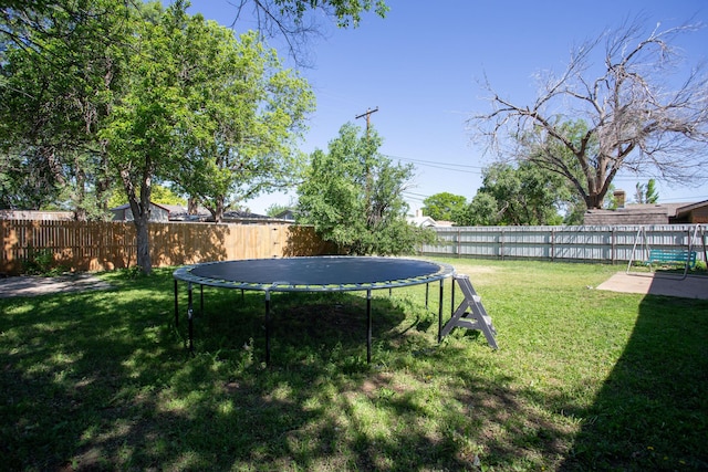 view of yard with a trampoline