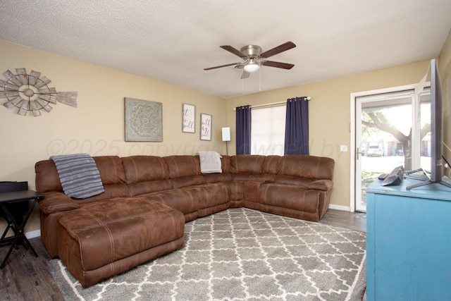 living area with ceiling fan, wood finished floors, and baseboards