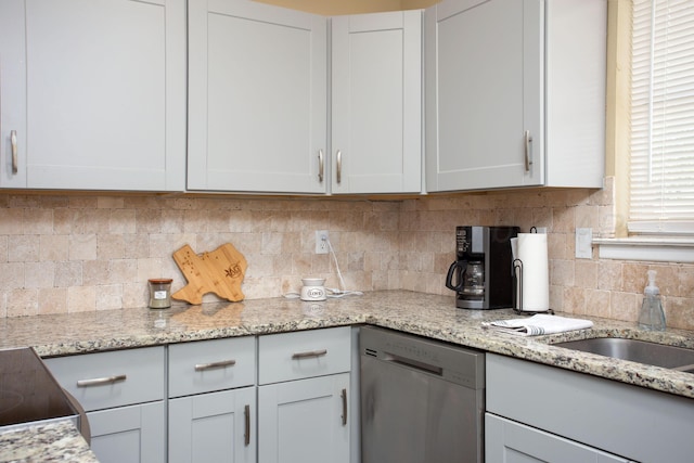 kitchen with dishwasher, white cabinetry, decorative backsplash, and light stone counters