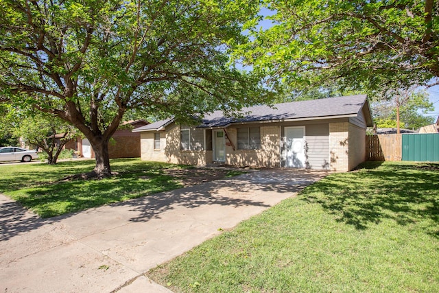 ranch-style house featuring brick siding and concrete driveway