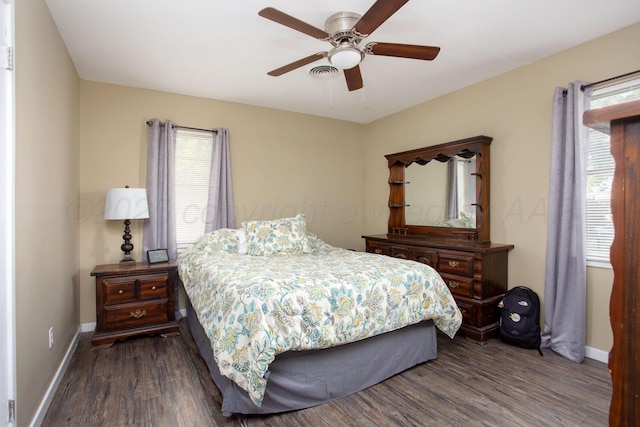bedroom with baseboards, dark wood finished floors, and a ceiling fan