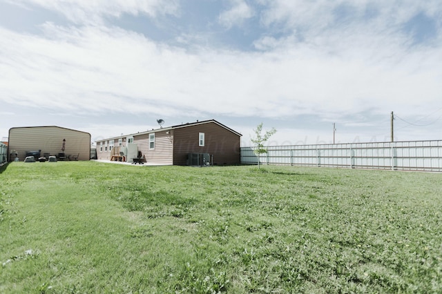 view of yard with fence and cooling unit