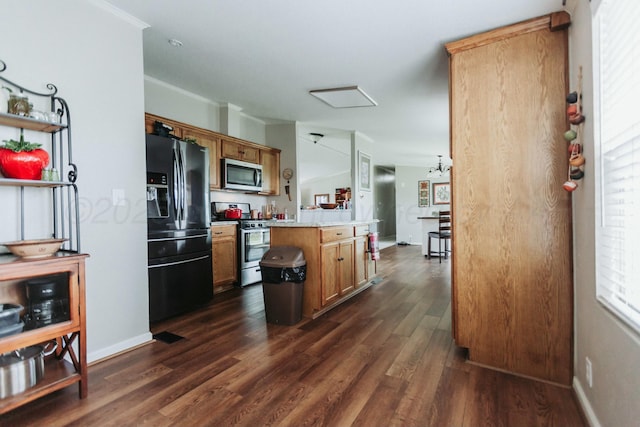 kitchen with a center island, light countertops, dark wood-style flooring, and stainless steel appliances
