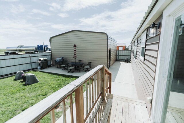 deck featuring fence private yard, a patio area, a yard, and a grill