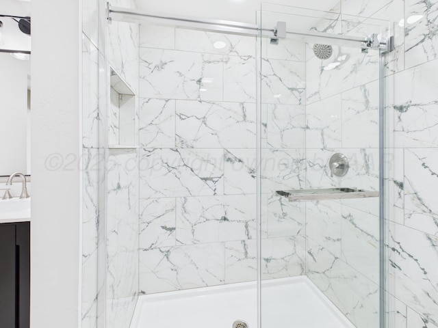 bathroom with a stall shower and vanity