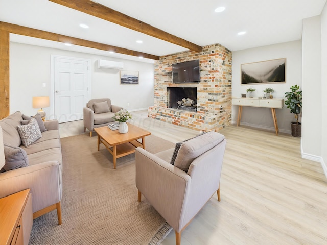 living area with beam ceiling, an AC wall unit, baseboards, and wood finished floors