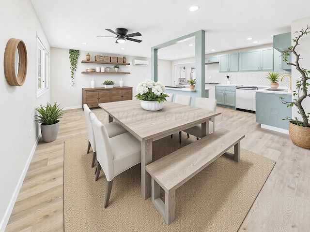 dining space with a wall mounted AC, recessed lighting, a ceiling fan, and light wood finished floors