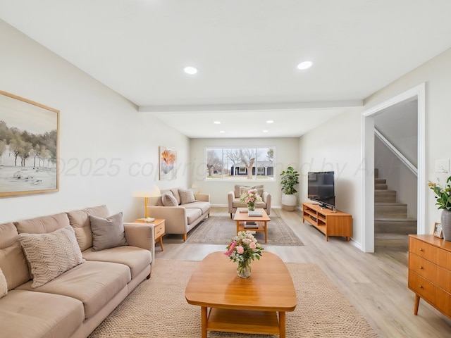 living area featuring baseboards, light wood-type flooring, stairway, and recessed lighting
