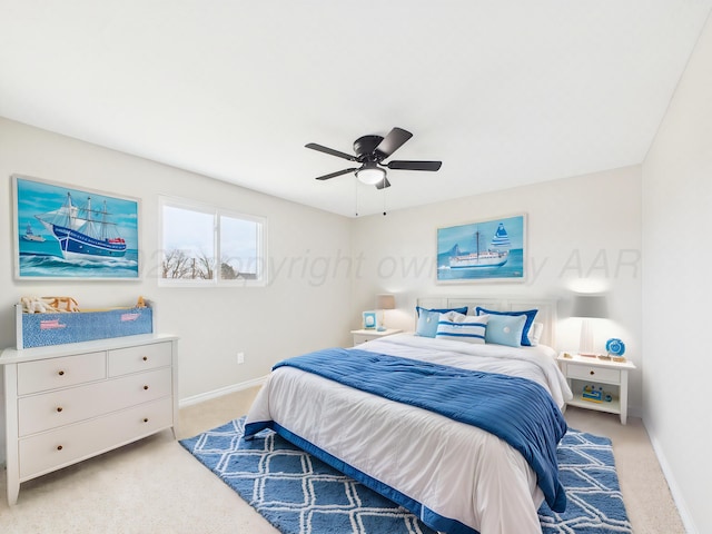 bedroom with light carpet, baseboards, and a ceiling fan
