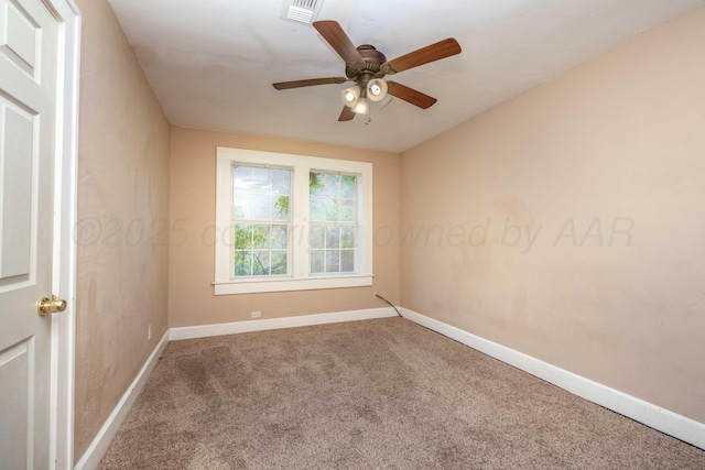 spare room featuring baseboards, a ceiling fan, carpet flooring, and visible vents