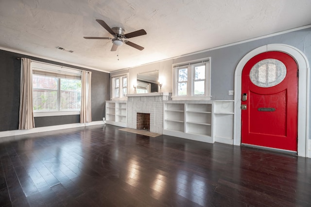 unfurnished living room featuring plenty of natural light, crown molding, ceiling fan, and hardwood / wood-style floors