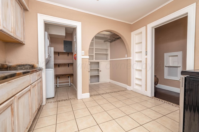 corridor featuring crown molding, built in features, baseboards, electric panel, and light tile patterned floors