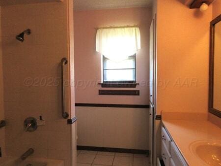 bathroom featuring tile patterned floors, shower / tub combination, and vanity