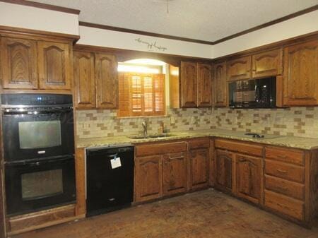kitchen featuring backsplash, a sink, black appliances, and ornamental molding