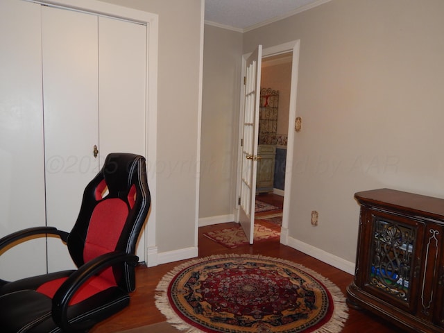 office space featuring ornamental molding, wood finished floors, and baseboards