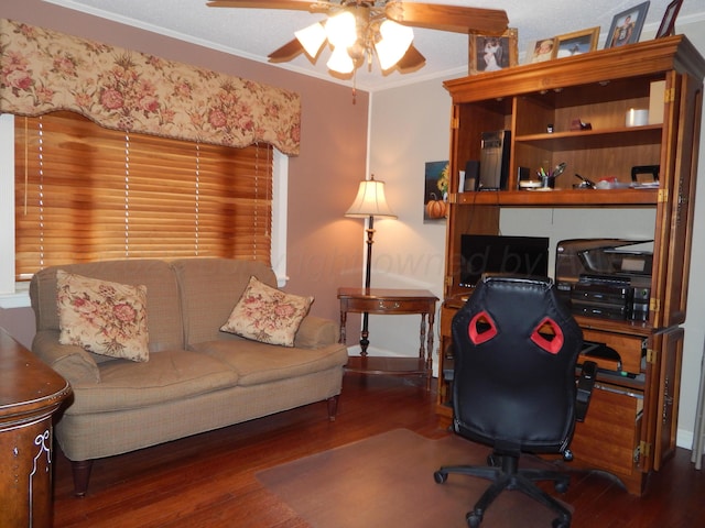 office space with baseboards, wood finished floors, a ceiling fan, and crown molding