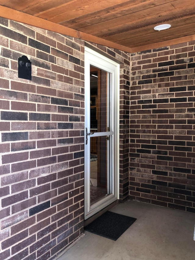 property entrance with brick siding