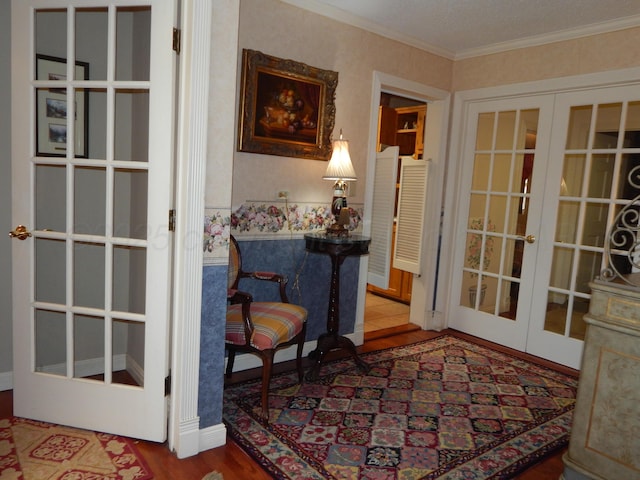 sitting room with crown molding, wood finished floors, french doors, and baseboards