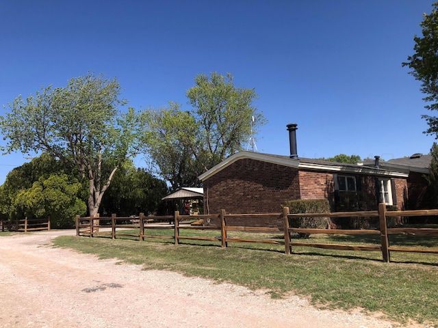 exterior space featuring fence and brick siding
