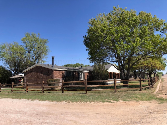 view of front of property featuring fence private yard and brick siding