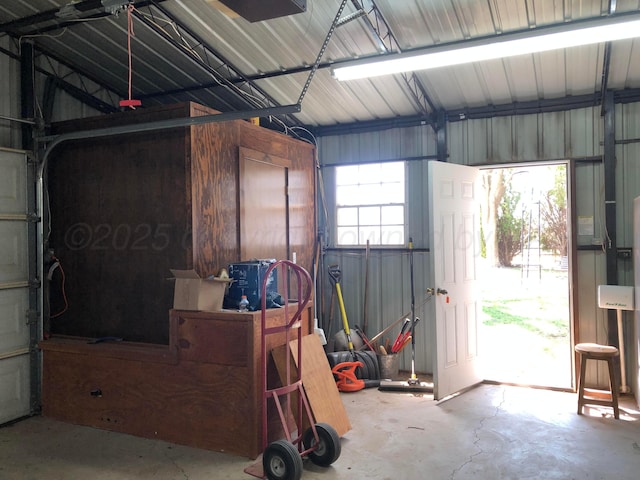 garage featuring metal wall and a garage door opener