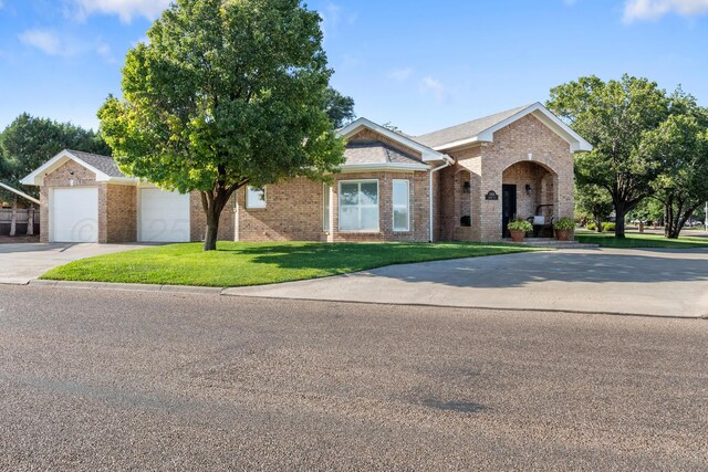 1918 Arroya Rd, Dalhart, TX 79022 - view of front of home with a garage, brick siding, driveway, and a front lawn