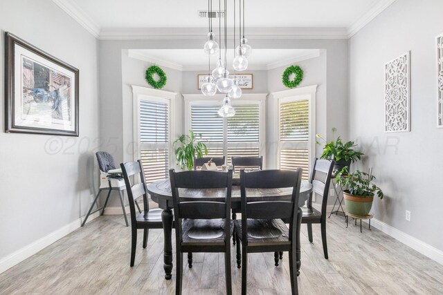 1918 Arroya Rd, Dalhart, TX 79022 - dining room with visible vents, baseboards, light wood finished floors, an inviting chandelier, and crown molding