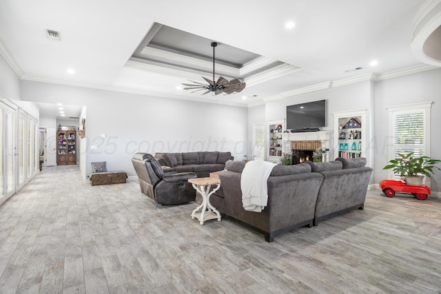 1918 Arroya Rd, Dalhart, TX 79022 - living room with light wood-style floors, a brick fireplace, visible vents, and a raised ceiling