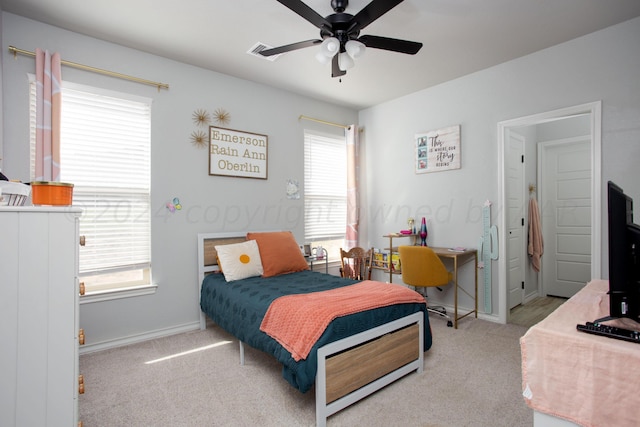 bedroom with ceiling fan and light colored carpet