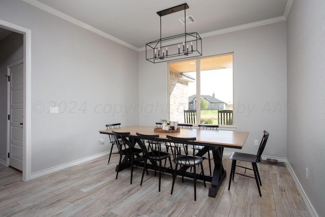 dining area with light hardwood / wood-style floors and crown molding